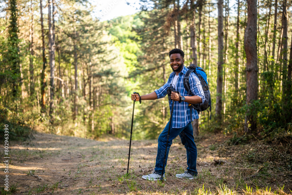 Fototapeta premium Young man enjoys hiking in nature.