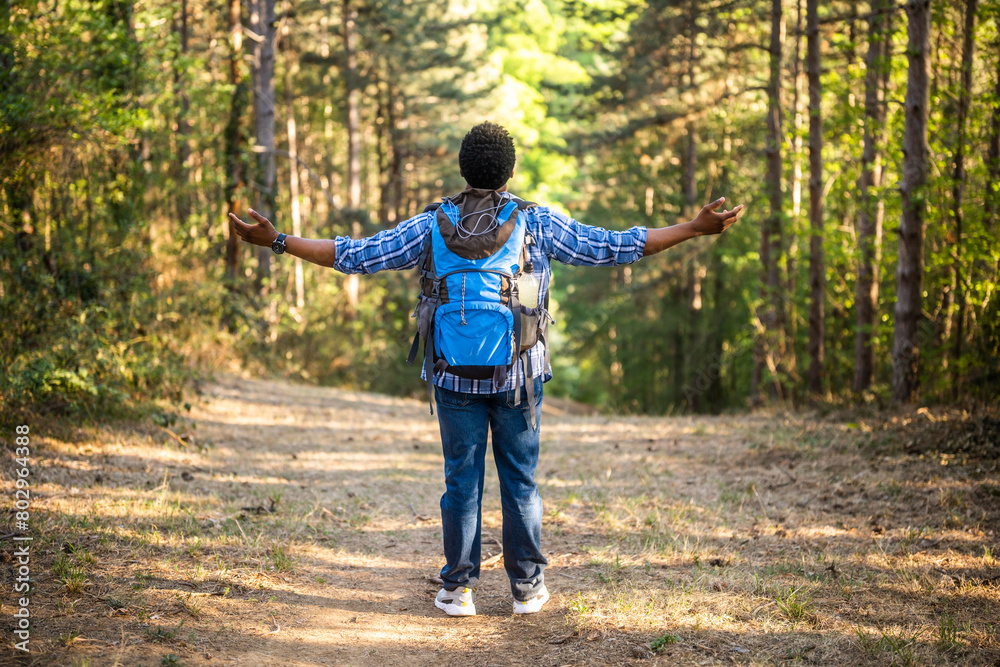 Happy man hiker with arms raised enjoys in the nature. Happy man hiker with arms raised enjoys in the nature.