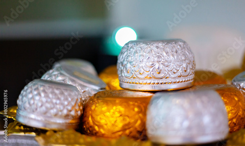 Golden bowl used in rituals in Thailand. Silver bowl in a floating tank with flowers. Used during Songkran festival.