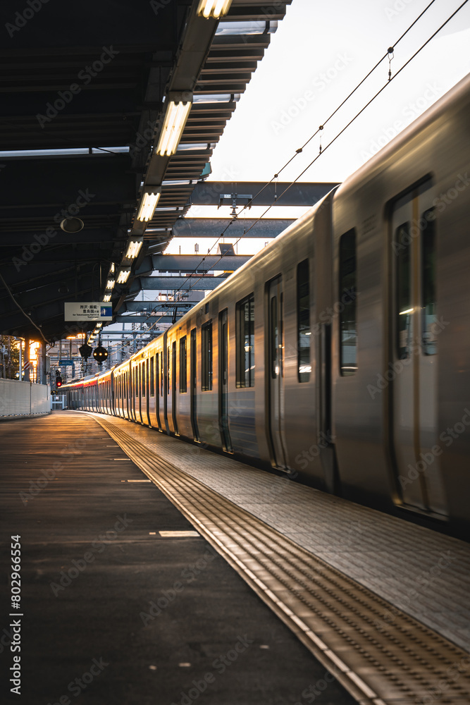 Station and moving trains in the evening sun.