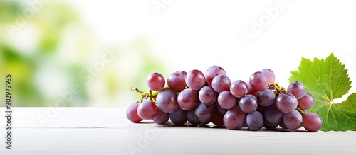 A copy space image of delicious sweet grapes arranged on a white wooden table photo