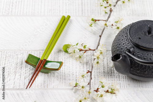 Table adorned with cherry blossom branch and chopsticks