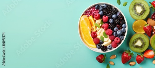 Fototapeta Naklejka Na Ścianę i Meble -  A colorful vibrant smoothie bowl topped with fresh fruits and nuts Perfect for a nutritious and delicious breakfast or snack Copy space image