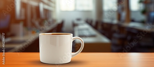 A copy space image of a coffee cup sitting on a desk in an office