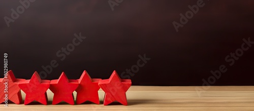 A chain of star shaped wooden cubes with one star featuring a red flag representing the commander Copy space image