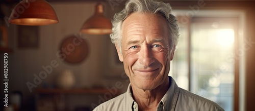 A copy space image features a captivating portrait of a senior man in his home displaying his handsome appearance and leaving room for additional text