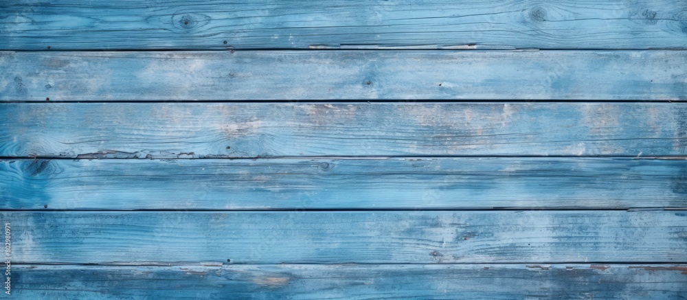 Fototapeta premium A beautiful background of an old blue wooden board is shown in a front view with copy space The board s vertical direction enhances the design providing a wooden background with traces of old paint