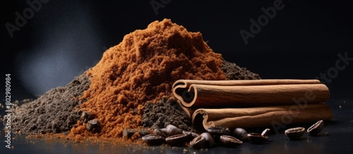 A copy space image featuring a rich heap of brown sugar coffee grounds and a Bourbon vanilla pod on a stylish grey background showcasing the Vanilla Queen of spices photo