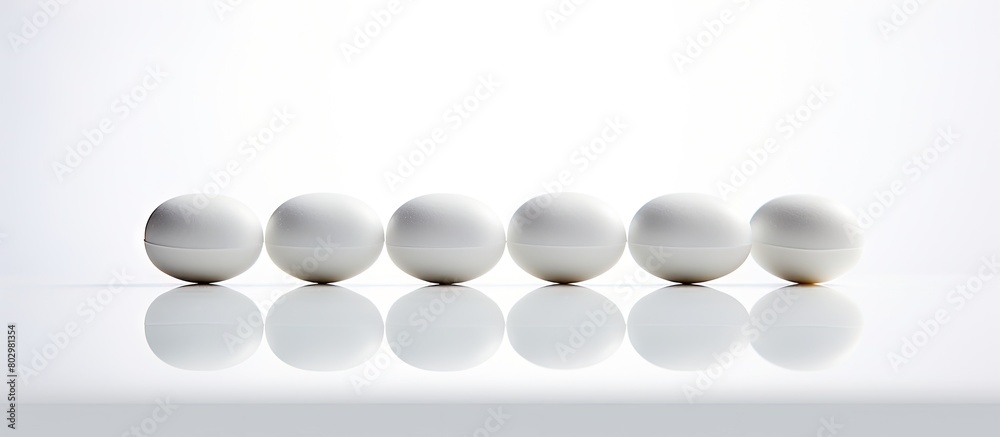 A copy space image showcasing three white pills against a white backdrop
