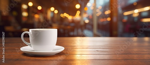 A coffee cup with a white color is placed on the table in the background of a lounge bar with empty space for images. with copy space image. Place for adding text or design