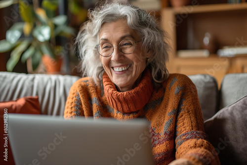 Smiling senior woman having a virtual call using her laptop at home