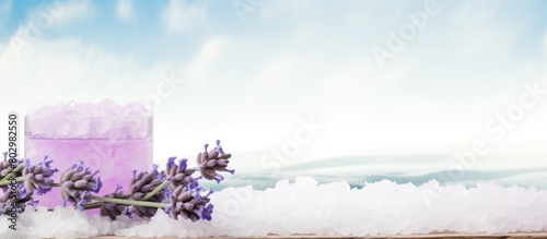 A copy space image of organic lavender soap and bath salt resting on a white wooden table