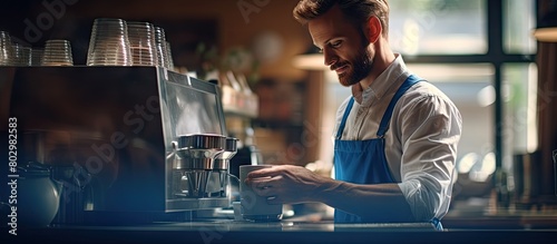 A barista at work in a cafe enjoying the scent of coffee in a cup as seen from the side copy space image