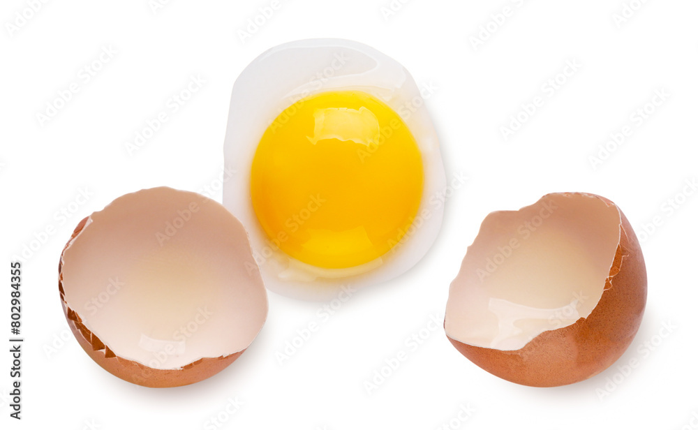 Broken egg, yolk and shell on a white background. Top view Broken egg, yolk and shell on a white background. Top view