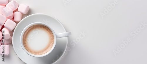 A cup of morning coffee with a pink marshmallow is displayed in a white oval dish against a gray background in a flat lay style The top down view provides ample copy space for additional elements