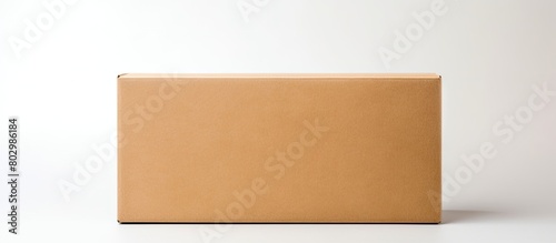 A child is seen holding a rectangular craft paper box against a plain white background representing the concept of parcel delivery in a top down view with copy space available © vxnaghiyev