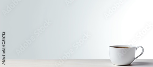 A cup placed alone with no other objects around set against a plain white backdrop creating ample empty space in the image