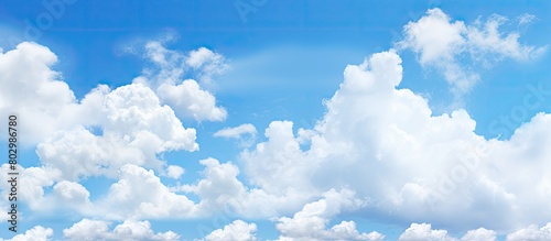 A copy space image with a backdrop of a clear blue sky dotted with fluffy white clouds