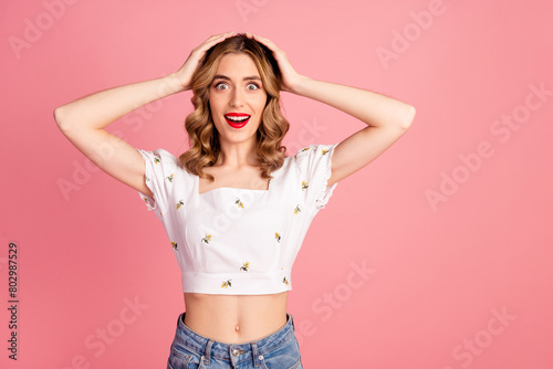 Photo portrait of pretty young girl touch head unbelievable wear trendy white outfit hairdo isolated on pink color background