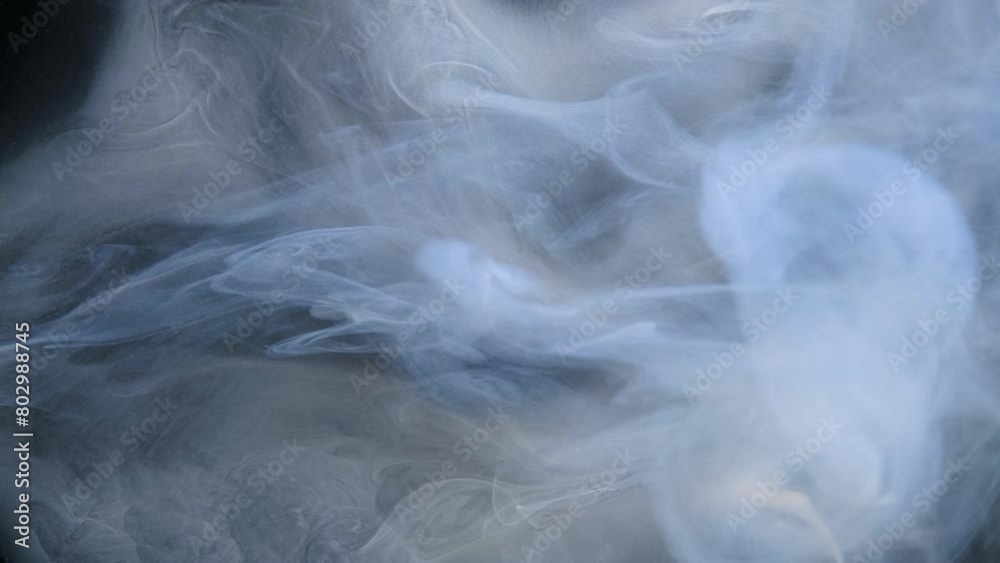 Wisps of smoke intertwine gracefully against a dark backdrop. Wisps of smoke intertwine gracefully against a dark backdrop.