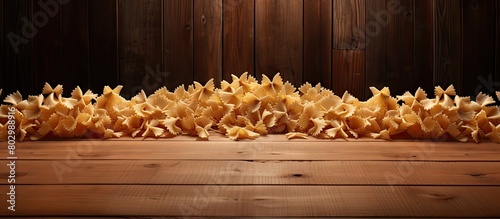 A copy space image showing Farfalle pasta drying on a rustic wooden desk photo