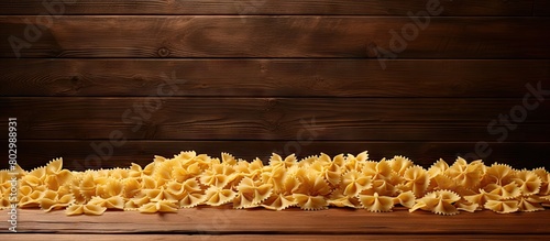 A copy space image showing Farfalle pasta drying on a rustic wooden desk photo