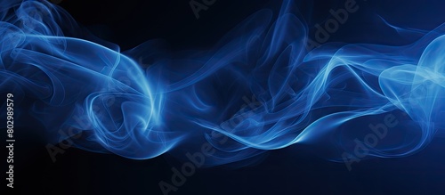 A blue vapor contrasting against a dark backdrop with ample room for additional content in the image photo