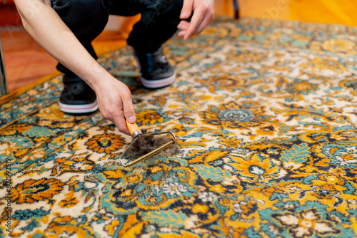 in the apartment master cleaner cleans the carpet using a wool scraper professional cleaning