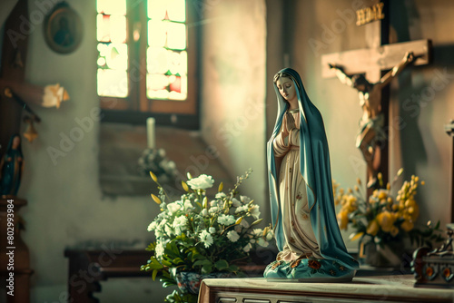 Statue of the Virgin Mary in a Christian church, A statue of Mary is sitting on a table in a church photo