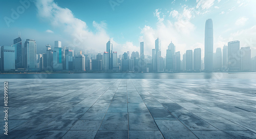 Empty asphalt floor background with modern city buildings and a blue sky, a panoramic view of an empty concrete platform that could be used for car presentations, taken from a low angle shot