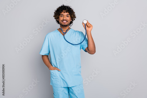 Photo of doctor guy use stethoscope listen heartbeat isolated grey color background photo