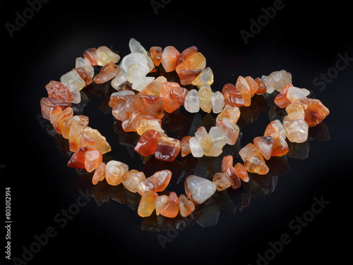 Carnelian stone  braceleton a black background . Bracelet made of stones on hand from natural Carnelian. Handmade jewelry bracelets .