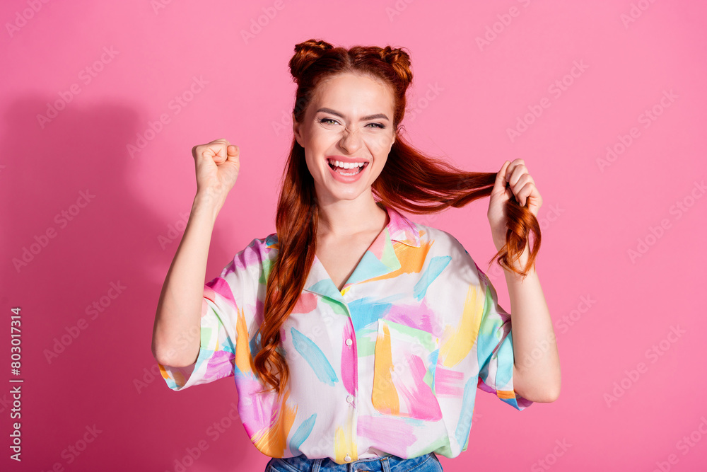 Portrait of optimistic overjoyed woman wear print shirt hand hold foxy hair going to make curl shorter isolated on pink color background Portrait of optimistic overjoyed woman wear print shirt hand hold foxy hair going to make curl shorter isolated on pink color background
