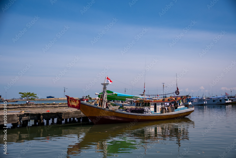 Brown wooden boats anchor at Paotere Traditional Harbour. Its located 4 km north of Makassar City. Brown wooden boats anchor at Paotere Traditional Harbour. Its located 4 km north of Makassar City.