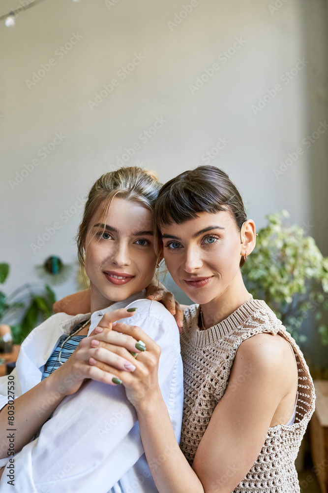 Two women, part of a tender lesbian couple, hugging in an arty studio setting. Two women, part of a tender lesbian couple, hugging in an arty studio setting.