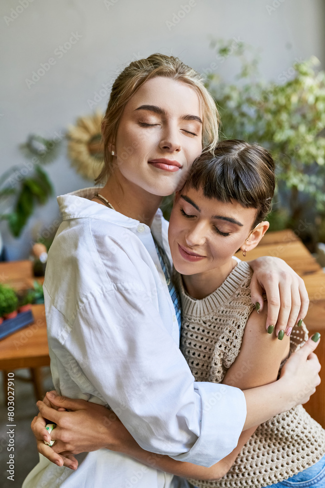 Fototapeta premium Two women sharing a heartfelt hug in an art studio.