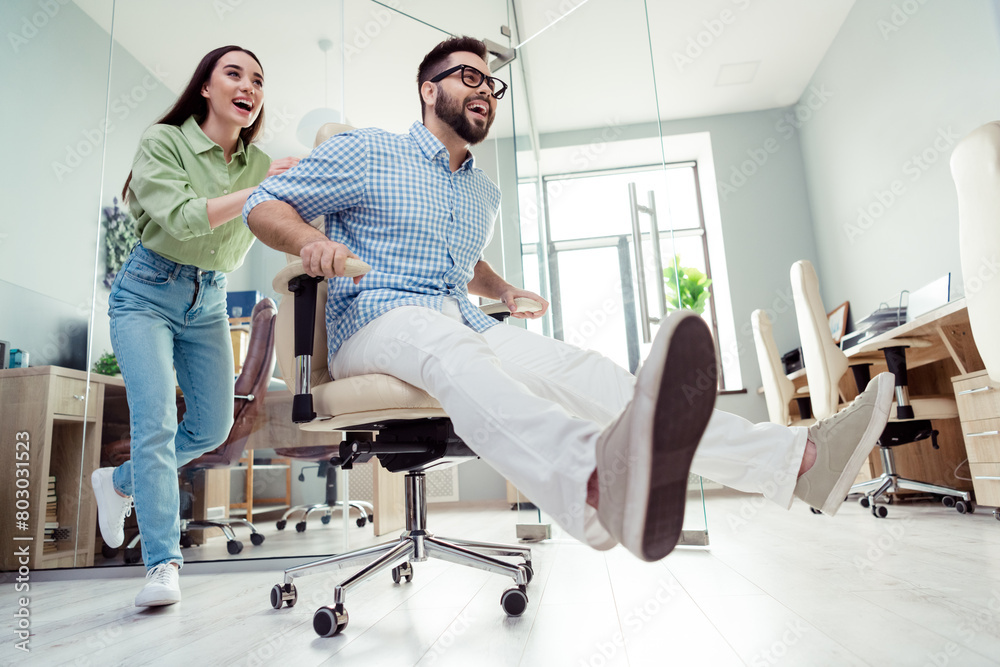Photo of positive good mood employers dressed shirts riding wheel chair indoors workshop workstation Photo of positive good mood employers dressed shirts riding wheel chair indoors workshop workstation