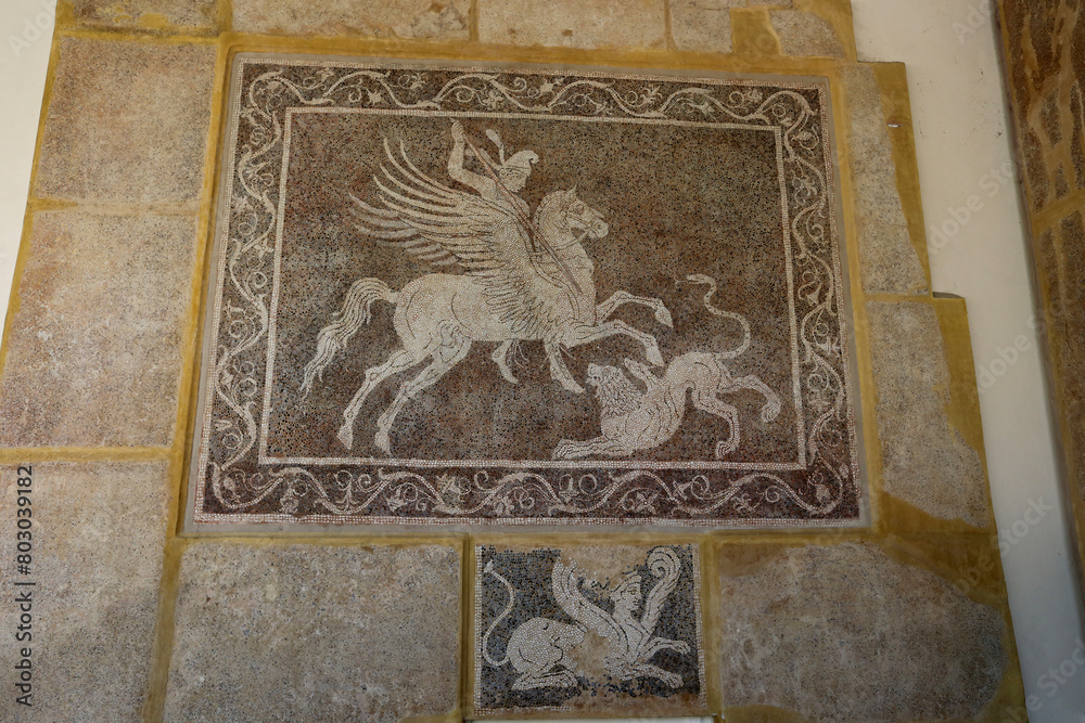 Rhodes, Greece - August 10, 2017: Mosaic depicting a rider fighting a lion at the Archaeological Museum on the island of Rhodes, Greece.