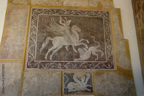Rhodes, Greece - August 10, 2017: Mosaic depicting a rider fighting a lion at the Archaeological Museum on the island of Rhodes, Greece. photo