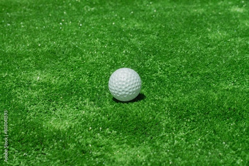 Golf ball on the green background