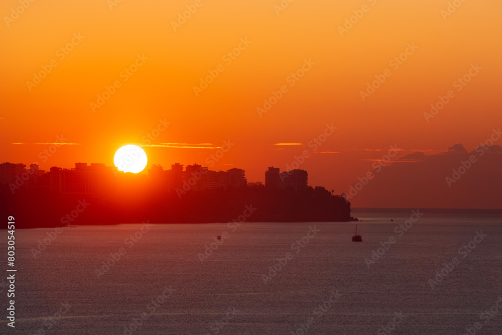 sun is rising over the city of antalya and shinning on the mediterranean sea