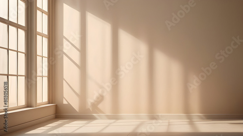 Minimalistic a light beige background for product presentation with light and intricate shadow from the window and wall