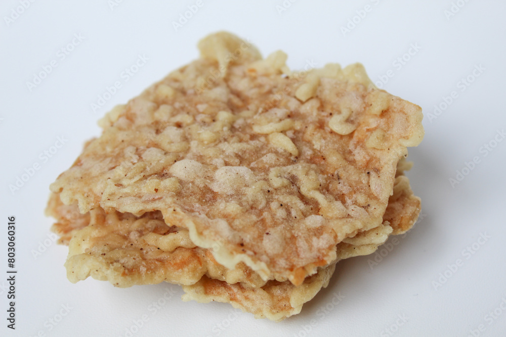 Keripik tempe or tempeh crackers, square shape. Thin slices tempeh, fried with flour dough. Isolated in white background Keripik tempe or tempeh crackers, square shape. Thin slices tempeh, fried with flour dough. Isolated in white background