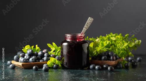 Blueberry jam and fresh berries with leaves. © Igor Normann