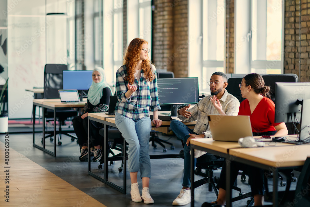 A diverse group of young business individuals congregates in a modern startup coworking center, embodying collaborative innovation and a dynamic atmosphere