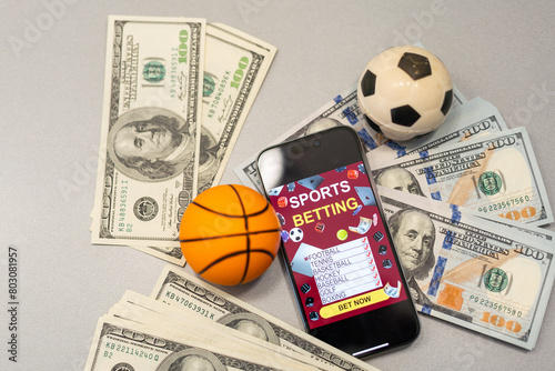 Basketball ball, smartphone with application and banknote of 100 dollars. Betting