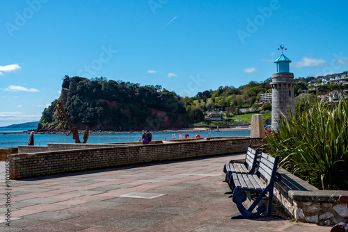 Benches and Seaside promenade with lighthouse and the cliffs. photo