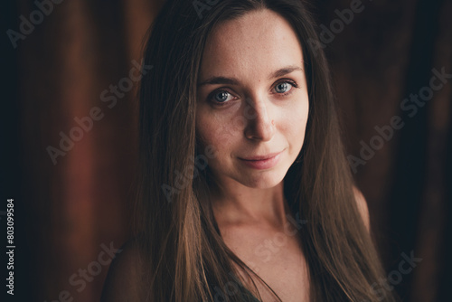 No retouch portrait of gorgeous adorable positive woman with long blond hairstyle mole on nose look at camera in dark studio light