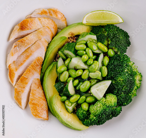 Healthy grilled chicken plate with vegetables and lime