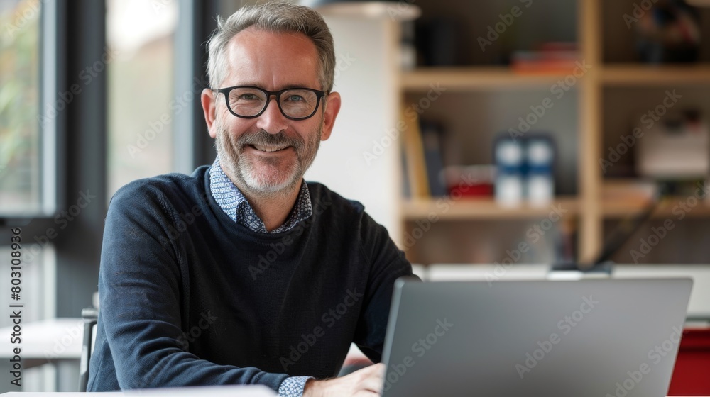 Smiling Man with Laptop in Office Smiling Man with Laptop in Office